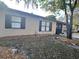 A single-story home with neutral siding, dark shutters, and minimal landscaping for a clean, simple exterior at 5298 Rose Ave, Orlando, FL 32810