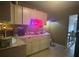 Cozy kitchen area with lighter cabinets, with a coffee bar and neon sign at 5298 Rose Ave, Orlando, FL 32810