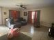 Living room showing a ceiling fan, tile floors, and large windows at 5298 Rose Ave, Orlando, FL 32810