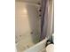 Bathroom with shower/tub combo with white tile, and accessible safety bar at 5427 Hansel Ave # 9, Orlando, FL 32809