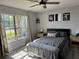 Serene bedroom featuring large window and soft lighting with ceiling fan and tasteful decor at 5427 Hansel Ave # 9, Orlando, FL 32809