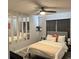Cozy bedroom with soft lighting, a ceiling fan, mirror features, and neutral décor at 5427 Hansel Ave # 9, Orlando, FL 32809