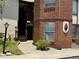 Red brick exterior of condo building with stairway and walkway leading to main entrance at 5427 Hansel Ave # 9, Orlando, FL 32809