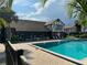 Community pool with lounge chairs and shaded seating areas surrounded by lush landscaping at 5427 Hansel Ave # 9, Orlando, FL 32809