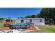 Exterior view of home featuring an above-ground pool with deck and spacious backyard at 6222 Dovecrest Trl, Lakeland, FL 33810