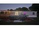 Dusk exterior with deck and above ground pool at 6222 Dovecrest Trl, Lakeland, FL 33810