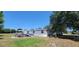 Exterior view of a home featuring a covered deck, above-ground pool, and expansive backyard at 6222 Dovecrest Trl, Lakeland, FL 33810