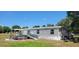 Exterior of home featuring an above ground pool, covered deck and spacious backyard at 6222 Dovecrest Trl, Lakeland, FL 33810