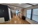 Open-concept living space featuring wood floors, a decorative partition, and abundant natural light from the window at 6222 Dovecrest Trl, Lakeland, FL 33810