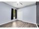 This cozy bedroom features wood-look floors, a ceiling fan, and a closet at 640 Brookfield Pl, Apopka, FL 32712