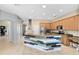 Open kitchen boasts wooden cabinets, and a center island with tile accents at 640 Brookfield Pl, Apopka, FL 32712