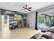 Open living room featuring a wooden accent wall and sliding doors to the pool at 640 Brookfield Pl, Apopka, FL 32712