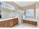 Bathroom featuring double sinks, a separate glass shower, and a soaking tub at 640 Brookfield Pl, Apopka, FL 32712