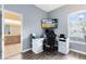 Well-lit office space with hardwood floors, a large window, and view to the bathroom at 640 Brookfield Pl, Apopka, FL 32712