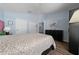 Light and airy bedroom has hardwood floors and is decorated with art and modern furniture at 654 Chadbury Way, Kissimmee, FL 34744