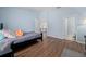 Light and airy bedroom with wood floors is open to the hallway and an en suite bathroom at 654 Chadbury Way, Kissimmee, FL 34744