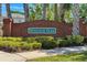 Brick sign for Windsor Park community with manicured hedges, suggesting a well-maintained neighborhood at 654 Chadbury Way, Kissimmee, FL 34744