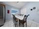 Dining area with stainless steel refrigerator, a table, and bright lighting at 654 Chadbury Way, Kissimmee, FL 34744