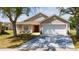Charming single-story home featuring an attached two-car garage and a well-manicured front yard at 654 Chadbury Way, Kissimmee, FL 34744
