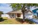 Charming home with a front porch, two-car garage and well-kept lawn providing lovely curb appeal at 654 Chadbury Way, Kissimmee, FL 34744