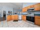 Kitchen with stainless steel appliances and light oak cabinets at 654 Chadbury Way, Kissimmee, FL 34744