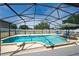 Inviting screened pool with a connected spa and clear blue water at 654 Chadbury Way, Kissimmee, FL 34744