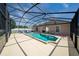 Enclosed pool and patio area featuring lounge seating and a clear blue sky at 654 Chadbury Way, Kissimmee, FL 34744