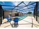 Screened pool area including a spa, lounge chairs, and covered patio at 654 Chadbury Way, Kissimmee, FL 34744