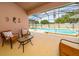 Screened-in patio with seating has a great view of the large private pool at 654 Chadbury Way, Kissimmee, FL 34744