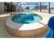 In-ground screened spa featuring tile and clear blue water at 654 Chadbury Way, Kissimmee, FL 34744