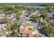A neighborhood aerial view featuring tree-lined streets, well-maintained homes, and a beautiful lake at 6559 Grosvenor Ln, Orlando, FL 32835