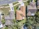 An aerial view of a home with a well-maintained roof, backyard, patio, and lush landscaping at 6559 Grosvenor Ln, Orlando, FL 32835