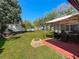 Expansive backyard featuring a patio, fire pit, and plenty of space for outdoor activities at 6559 Grosvenor Ln, Orlando, FL 32835
