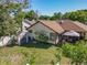 Aerial view of a backyard featuring a well-manicured lawn, patio with gazebo, and storage shed at 6559 Grosvenor Ln, Orlando, FL 32835