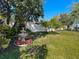 Landscaped backyard features a fountain and mature trees at 6559 Grosvenor Ln, Orlando, FL 32835