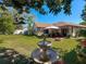 Lush backyard featuring a fountain and view of the home at 6559 Grosvenor Ln, Orlando, FL 32835