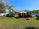 This backyard features a patio with gazebo, well-kept lawn, fire pit, and storage shed at 6559 Grosvenor Ln, Orlando, FL 32835
