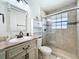 Bathroom featuring a glass shower and marble sink at 6559 Grosvenor Ln, Orlando, FL 32835