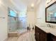 Modern en suite bathroom featuring tiled glass shower and vanity with dark wood cabinets at 6559 Grosvenor Ln, Orlando, FL 32835