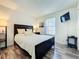 Cozy bedroom features a comfortable bed, wood floors, and a mounted TV at 6559 Grosvenor Ln, Orlando, FL 32835
