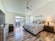 Bright bedroom with wood floors, ceiling fan, sliding glass doors to outdoor living space at 6559 Grosvenor Ln, Orlando, FL 32835