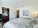 Bedroom with wood floors, closet, and open door to a hallway at 6559 Grosvenor Ln, Orlando, FL 32835