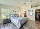 Bedroom with wood floors features a view to a walk-in closet and en suite bathroom at 6559 Grosvenor Ln, Orlando, FL 32835