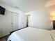 Bright bedroom with wood floors, closet, and access to other areas of the home at 6559 Grosvenor Ln, Orlando, FL 32835