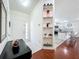 Welcoming entryway with stylish console table, tile flooring, and decorative shelving at 6559 Grosvenor Ln, Orlando, FL 32835