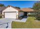 Charming single-Gathering home with a well-maintained lawn and an attached two-car garage at 6559 Grosvenor Ln, Orlando, FL 32835