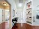 Inviting hallway with hardwood floors, stylish console table, and decorative built-in shelving at 6559 Grosvenor Ln, Orlando, FL 32835