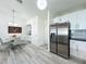 Modern kitchen features stainless steel appliances, white cabinets, and gray subway tile backsplash at 6559 Grosvenor Ln, Orlando, FL 32835