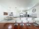Open-concept design connecting the kitchen, dining area, and breakfast bar, with modern finishes at 6559 Grosvenor Ln, Orlando, FL 32835