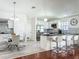 Modern kitchen features white cabinets, stainless steel appliances, and a breakfast bar at 6559 Grosvenor Ln, Orlando, FL 32835